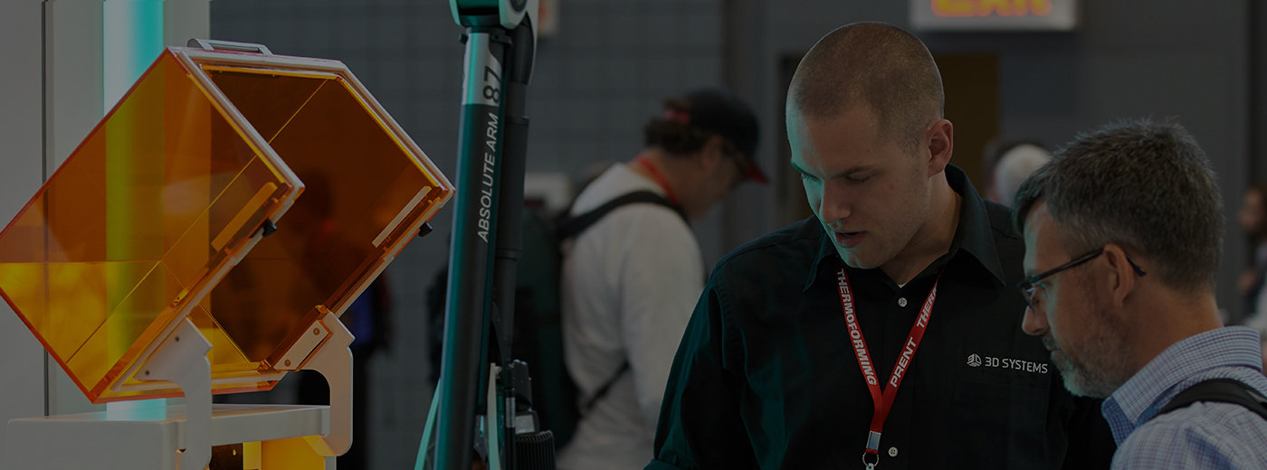 Exhibitor demonstrates product to attendee at MD&M Midwest