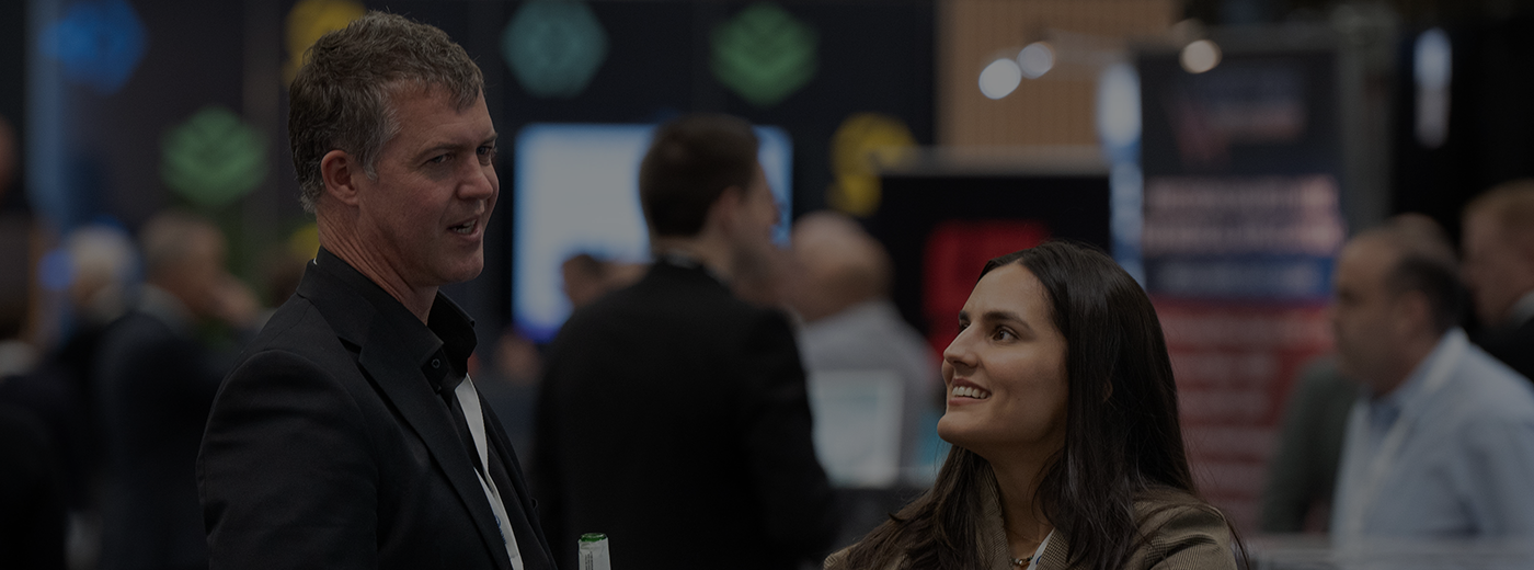 A man and a woman share a conversation in the expo hall