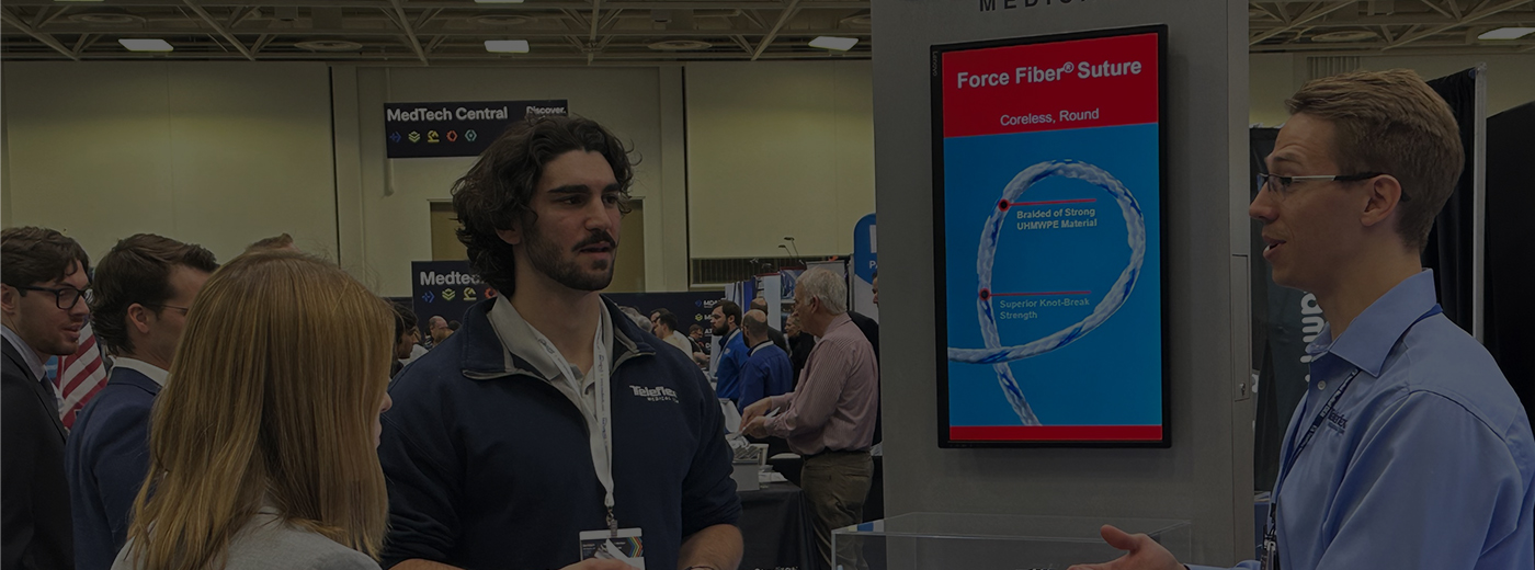 Attendees speak to an exhibitor at MD&M Midwest