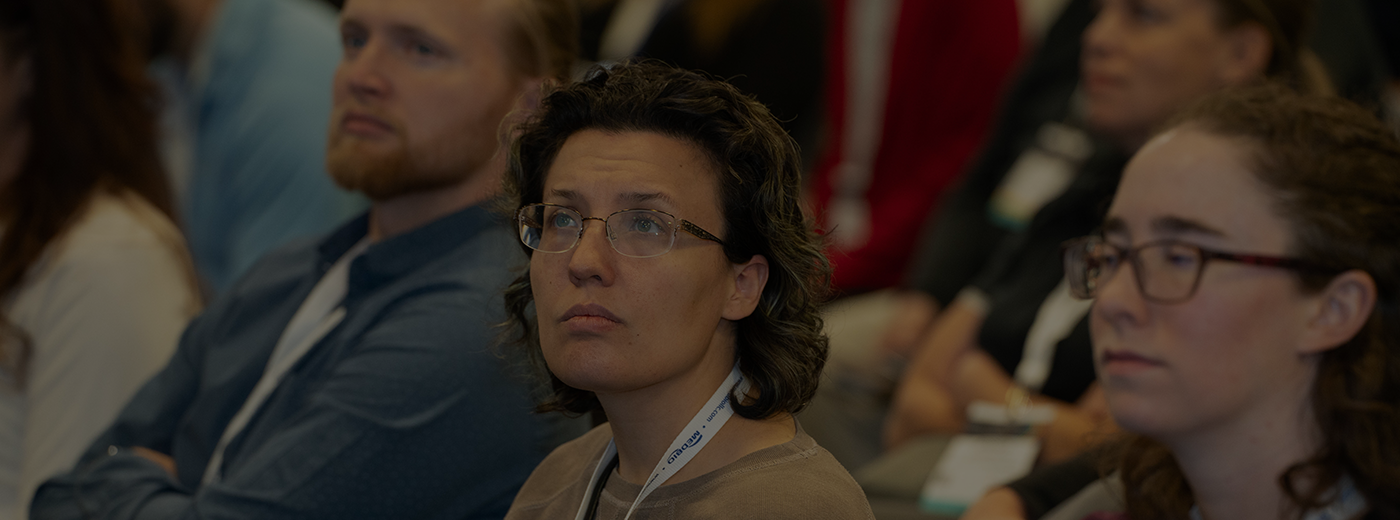 Woman in the audience listens to speaker