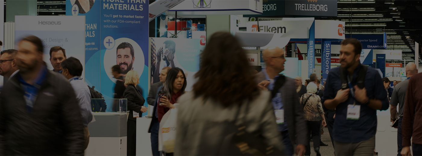 Attendees walk on the show floor