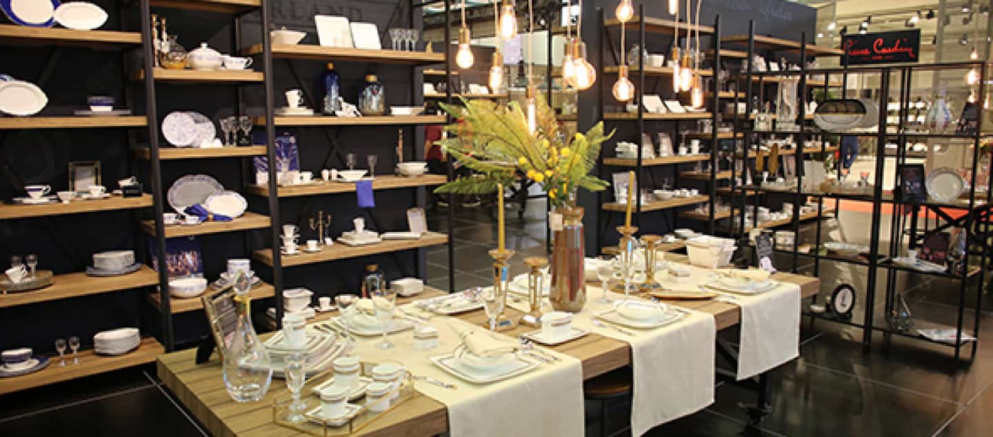 a luxurious table and shelves where porcelain products are displayed.