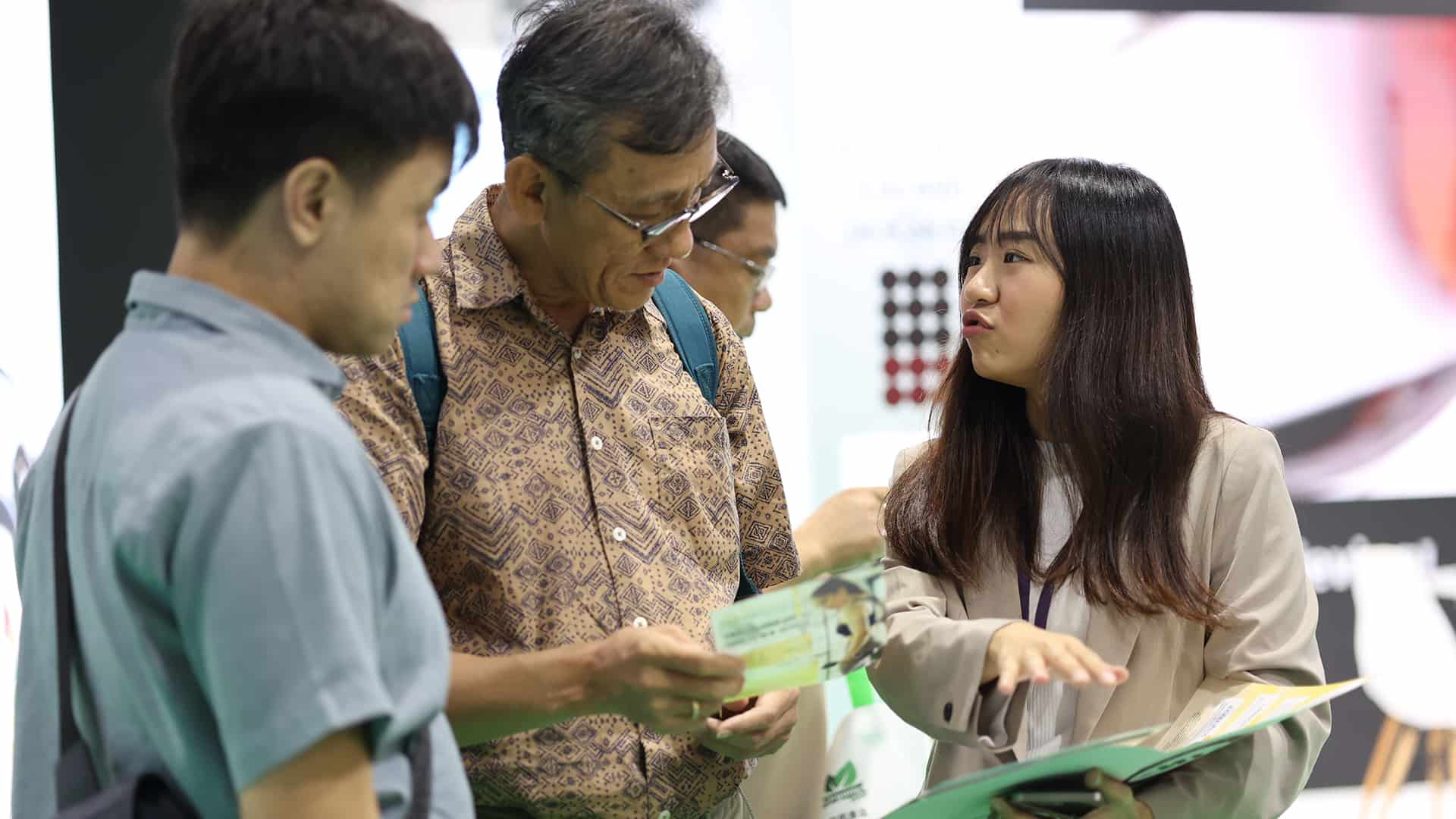 Three attendees chatting at Vitafood Asia.