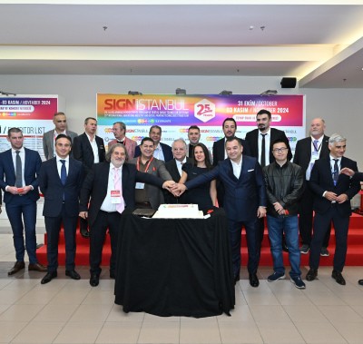 Group of people cutting a cake during the opening ceremony of SIGN İstanbul, celebrating the event's 25th anniversary