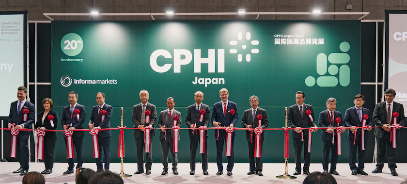 Group of pharma professionals cutting the ribbon at CPHI Japan event