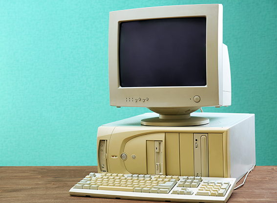 Obsolete computer set on light blue background