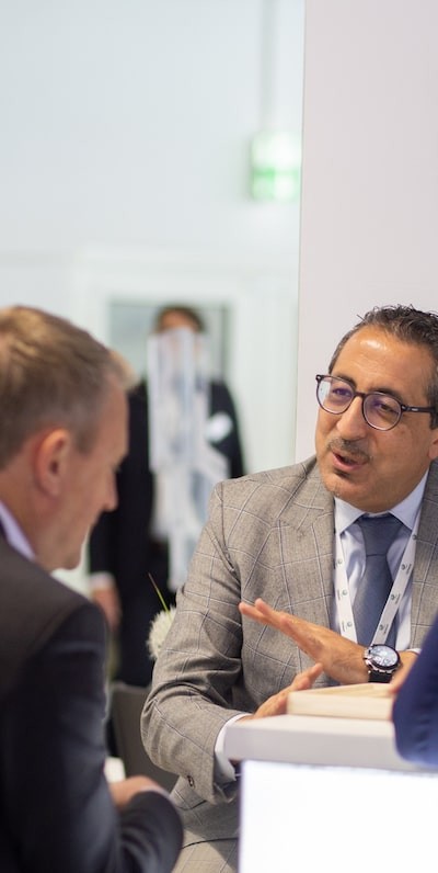 Two males in suits sat down having a meeting