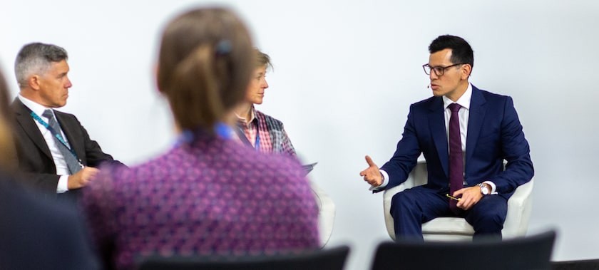 Male sat down having a conversation with an audience